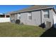 Spacious backyard offering a covered lanai, green grass, and an outdoor dining area at 10198 Oak Crest Rd, Orlando, FL 32829