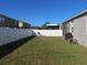 Expansive backyard with a white fence, covered lanai, and plenty of room for outdoor activities at 10198 Oak Crest Rd, Orlando, FL 32829