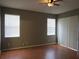 Bedroom with hardwood floors, ceiling fan, and abundant natural light at 10198 Oak Crest Rd, Orlando, FL 32829