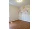 Charming bedroom featuring laminate wood flooring and stylish floral accent wall design at 10198 Oak Crest Rd, Orlando, FL 32829