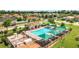 Aerial view of community pool with lounge chairs and shade umbrellas at 10198 Oak Crest Rd, Orlando, FL 32829