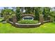Charming brick entrance sign to Oak Crest featuring beautiful landscaping at 10198 Oak Crest Rd, Orlando, FL 32829