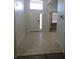 Bright entryway featuring neutral tile flooring and a transom window above the white front door at 10198 Oak Crest Rd, Orlando, FL 32829