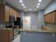 Well-lit kitchen featuring granite countertops, stainless steel appliances, and backsplash at 10198 Oak Crest Rd, Orlando, FL 32829
