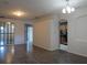 Spacious living area with wood-look flooring, multiple entryways, and ample natural light at 10198 Oak Crest Rd, Orlando, FL 32829