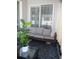 Cozy screened patio with neutral toned cushions and a glass table with black metal legs at 10198 Oak Crest Rd, Orlando, FL 32829