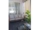 Comfortable seating on this screened lanai with sliding glass doors and a cozy, geometric rug at 10198 Oak Crest Rd, Orlando, FL 32829