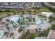 Aerial view of the community lazy river, cabanas, volley ball court, pool, and surrounding homes at 1593 Mulligan Blvd, Davenport, FL 33896