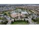 An aerial view showcases the community pool, clubhouse, palm trees and surrounding neighborhood at 1593 Mulligan Blvd, Davenport, FL 33896