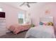 Charming pink bedroom with two beds, soft lighting, and whimsical decor at 1593 Mulligan Blvd, Davenport, FL 33896