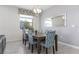 Charming dining room with stylish chairs, modern light fixture and ample natural light at 1593 Mulligan Blvd, Davenport, FL 33896
