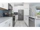 Well-appointed kitchen boasting stainless steel appliances, gray backsplash, and quartz countertops at 1593 Mulligan Blvd, Davenport, FL 33896