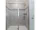 Modern shower with glass doors, tiled walls, built-in shelves, and updated fixtures at 1593 Mulligan Blvd, Davenport, FL 33896