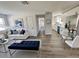 Bright living room with white sofa, blue accents, and an open layout to the kitchen and hallway at 603 Conrad Dr, New Smyrna Beach, FL 32168