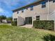 A charming backyard area featuring a sliding glass door, privacy fence, patio, and a well-maintained lawn at 1106 Presidential Ln, Apopka, FL 32703