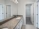 Bathroom features double vanity, granite countertop, and walk-in closet at 1106 Presidential Ln, Apopka, FL 32703