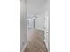 A bright hallway with wood-style floors leading to a large, open living area at 1106 Presidential Ln, Apopka, FL 32703