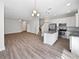 Open concept kitchen with granite countertops, island, stainless steel appliances, and hardwood flooring at 1106 Presidential Ln, Apopka, FL 32703