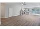 Bright, open-concept living area with hardwood floors and a ceiling fan at 1106 Presidential Ln, Apopka, FL 32703