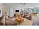 Inviting living room featuring neutral tones, modern furniture, ceiling fan and an open-concept layout at 1106 Presidential Ln, Apopka, FL 32703