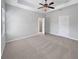 Spacious main bedroom featuring a trey ceiling, ceiling fan, soft carpet and a large closet at 1106 Presidential Ln, Apopka, FL 32703