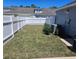 Well-maintained backyard featuring a white fence, lush lawn, and easy access at 14053 Wild Majestic St, Orlando, FL 32828