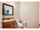 Small bathroom with granite countertop and wood cabinet at 2399 Parkside Glen Dr, Apopka, FL 32712