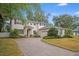 Two-story house with gray siding, brick accents, and a paved driveway at 2399 Parkside Glen Dr, Apopka, FL 32712