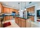 Spacious kitchen with ample cabinetry, granite countertops, and an island at 2399 Parkside Glen Dr, Apopka, FL 32712