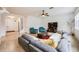 Spacious living room with gray sectional sofa and two teal armchairs at 2399 Parkside Glen Dr, Apopka, FL 32712