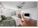 Large main bedroom with wood floors and a view of the backyard at 2399 Parkside Glen Dr, Apopka, FL 32712