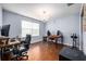Home office with wood floors and built-in shelving at 2399 Parkside Glen Dr, Apopka, FL 32712