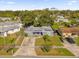 Aerial shot of a single-story home with a gray roof, surrounded by mature trees and green lawns at 4535 Arch St, Orlando, FL 32808