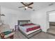 Bedroom featuring a queen-sized bed, ceiling fan, and a chair at 4535 Arch St, Orlando, FL 32808