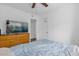 Bedroom with ceiling fan, dresser, and large bed at 4535 Arch St, Orlando, FL 32808