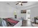 Main bedroom with TV, ceiling fan, and access to other rooms at 4535 Arch St, Orlando, FL 32808