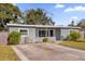 Charming single story home featuring a spacious front yard with tidy landscaping and a concrete driveway at 4535 Arch St, Orlando, FL 32808