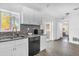 Bright kitchen with white cabinets, stainless steel appliances, and mosaic tile backsplash at 4535 Arch St, Orlando, FL 32808