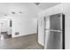 Kitchen area with stainless steel refrigerator and hardwood flooring at 4535 Arch St, Orlando, FL 32808
