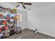 Room featuring laminate flooring, a storage unit overflowing with goods, and a pet crate on the floor at 4535 Arch St, Orlando, FL 32808