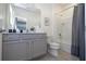Functional bathroom with a shower-tub combo, gray vanity, and fresh decor at 6240 Sand Skipper Rd, Orlando, FL 32821