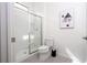 Clean bathroom featuring a walk-in shower, toilet, and modern vanity area with framed art at 6240 Sand Skipper Rd, Orlando, FL 32821