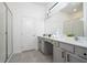 Bright bathroom features double vanity, granite countertop, sleek fixtures, a large mirror, and tiled floors at 6240 Sand Skipper Rd, Orlando, FL 32821