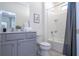 Bathroom features vanity with granite countertop, shower-tub combination, and neutral decor at 6240 Sand Skipper Rd, Orlando, FL 32821