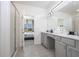 This bathroom features ample lighting, double sinks, and a modern glass shower at 6240 Sand Skipper Rd, Orlando, FL 32821