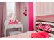Charming bedroom with pink striped walls, vanity table, and Barbie themed decor at 6240 Sand Skipper Rd, Orlando, FL 32821