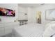 Modern bedroom with a TV, closet, and view into the adjoining bathroom at 6240 Sand Skipper Rd, Orlando, FL 32821