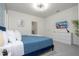Comfortable bedroom with a blue bed, stylish decor, and a TV for entertainment at 6240 Sand Skipper Rd, Orlando, FL 32821