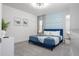 Cozy bedroom featuring a blue bed, patterned accent wall, and soft carpet for comfort at 6240 Sand Skipper Rd, Orlando, FL 32821