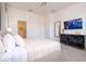 Bright bedroom featuring neutral tones, a TV, dresser, and a comfortable bed, creating a relaxing atmosphere at 6240 Sand Skipper Rd, Orlando, FL 32821